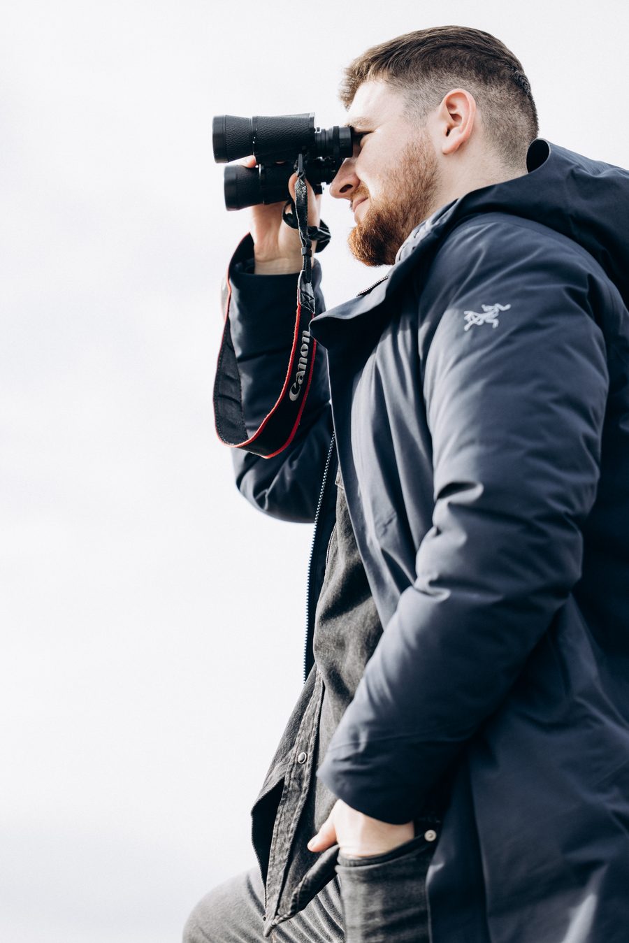 Sviatoslav scanning the horizon with binoculars